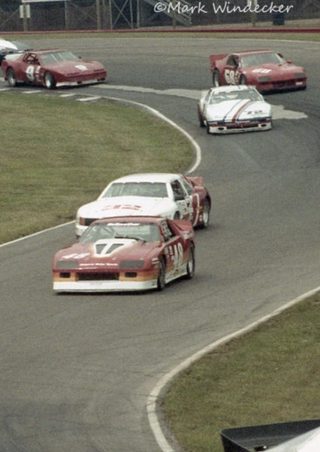 The striped #72 mid-pack in a Trans-Am field