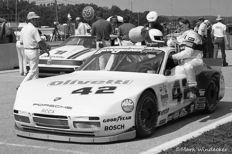 Bruce Jenner climbing into the #42 Porsche 944 in the pit lane