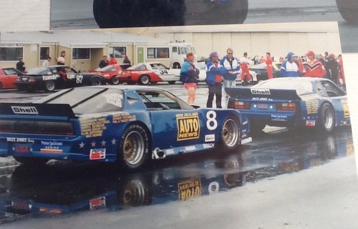 The blue #8 Pontiac and the team's Porsche in the wet Wigram paddock